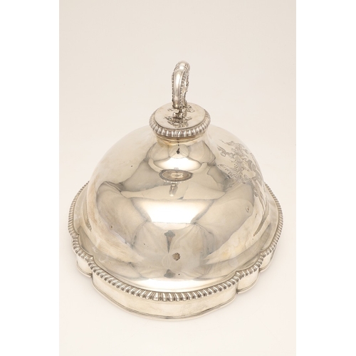 25 - A GEORGE III CRESTED SILVER MEAT DISH COVER. Of shaped-serpentine form, with gadrooned rim, engraved... 