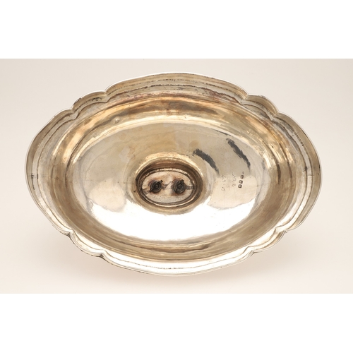 25 - A GEORGE III CRESTED SILVER MEAT DISH COVER. Of shaped-serpentine form, with gadrooned rim, engraved... 