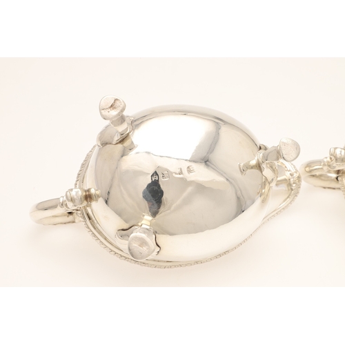 26 - A PAIR OF GEORGE III SILVER SAUCE BOATS. Each one featuring a heavy gadrooned border and scroll hand... 