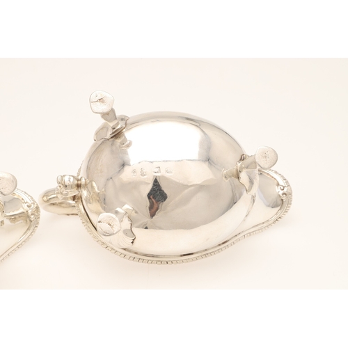 26 - A PAIR OF GEORGE III SILVER SAUCE BOATS. Each one featuring a heavy gadrooned border and scroll hand... 
