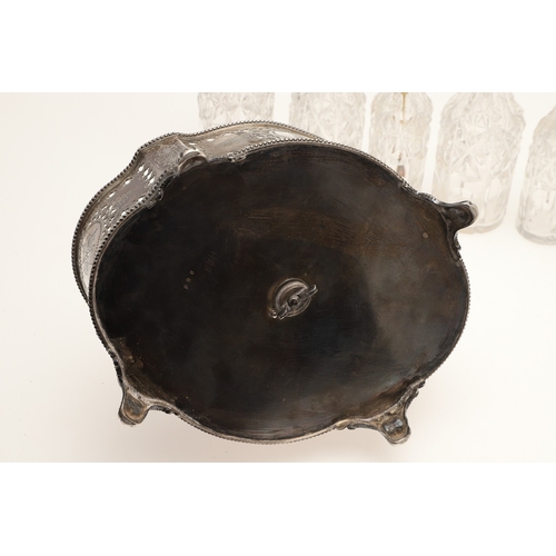 27 - A VICTORIAN SILVER SEVEN PIECE CRUET SET ON STAND. The stand with beaded border, pierced and engrave... 