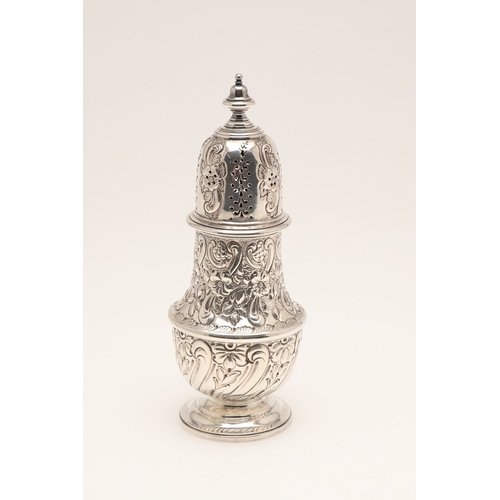 33 - A LARGE EDWARDIAN BALUSTER CASTER. On a spreading foot, the body embossed with floral and foliate de... 