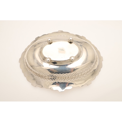 36 - AN EDWARDIAN SILVER TABLE BASKET. Of oval form with shaped border, pierced design and engraved decor... 