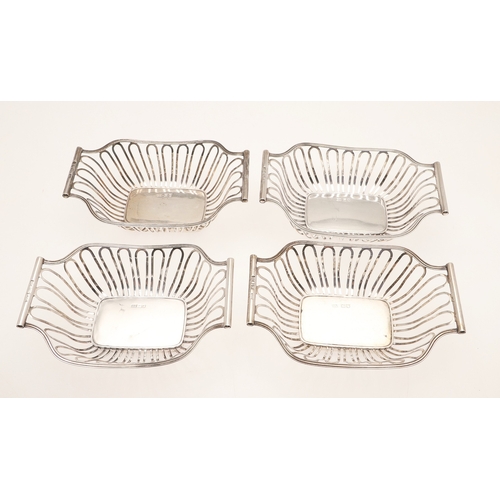 40 - A SET OF FOUR EDWARDIAN SILVER BON BON DISHES. Of shaped rectangular form with wirework style decora... 