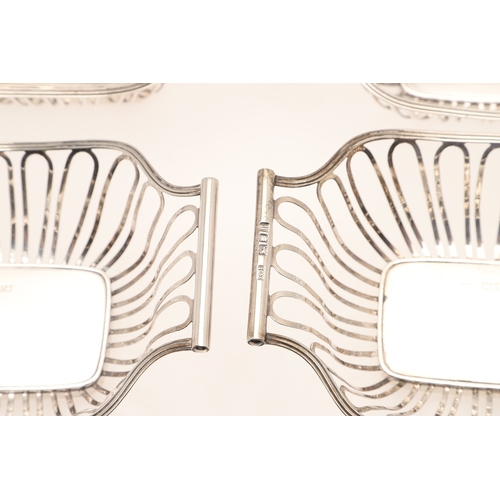 40 - A SET OF FOUR EDWARDIAN SILVER BON BON DISHES. Of shaped rectangular form with wirework style decora... 