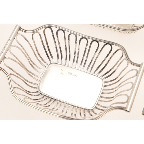 40 - A SET OF FOUR EDWARDIAN SILVER BON BON DISHES. Of shaped rectangular form with wirework style decora... 