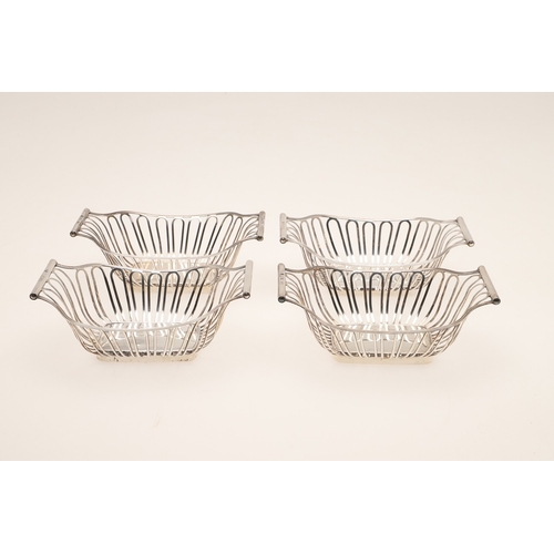 40 - A SET OF FOUR EDWARDIAN SILVER BON BON DISHES. Of shaped rectangular form with wirework style decora... 