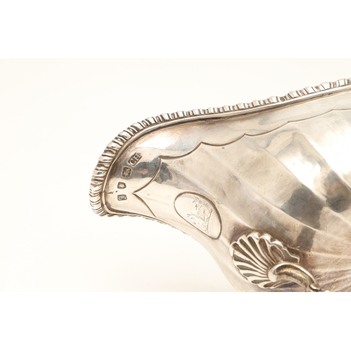 43 - AN EARLY GEORGE III SILVER SAUCE BOAT. With gadrooned border and scalloped edge faceted body, scroll... 