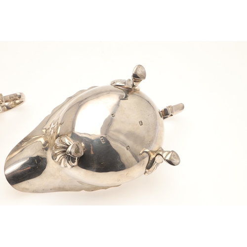 44 - A PAIR OF SILVER SAUCE BOATS. With card cut border, scroll handle and stood on three hoofed feet. Ha... 