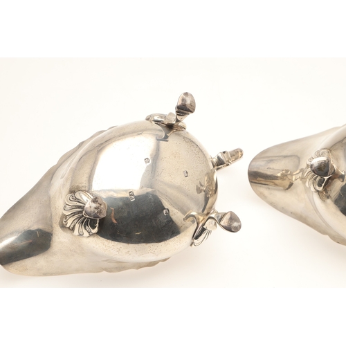 44 - A PAIR OF SILVER SAUCE BOATS. With card cut border, scroll handle and stood on three hoofed feet. Ha... 