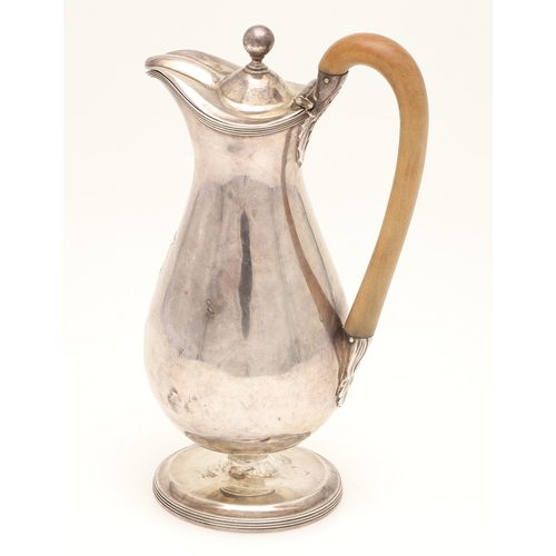 46 - A GEORGE III SILVER HOT WATER JUG. The lid with ball finial, the wooden handle with foliate decorate... 