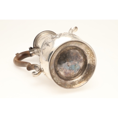 47 - AN EARLY GEORGE III SILVER COFFEE POT. With chased floral and foliate decoration, scroll handle and ... 