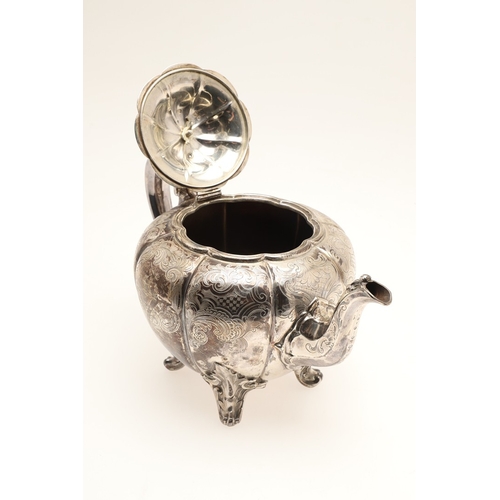 49 - A VICTORIAN ENGRAVED SILVER TEAPOT. Of melon form with engraved foliate scrolls, crested and initial... 