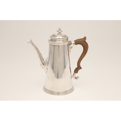 50 - A LATE VICTORIAN SILVER COFFEE POT. Of circular tapering form with carved fruitwood scroll handle an... 