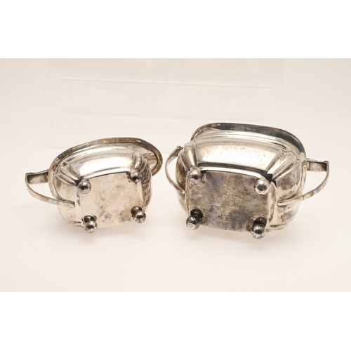 52 - AN EDWARDIAN SILVER FOUR PIECE TEA SET. Of shaped oblong form, with engraved foliate decoration, gad... 