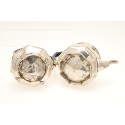 53 - AN EDWARDIAN SILVER FOUR PIECE OCTAGONAL FORM TEA SET. Comprising teapot and hot water/coffee pot, b... 