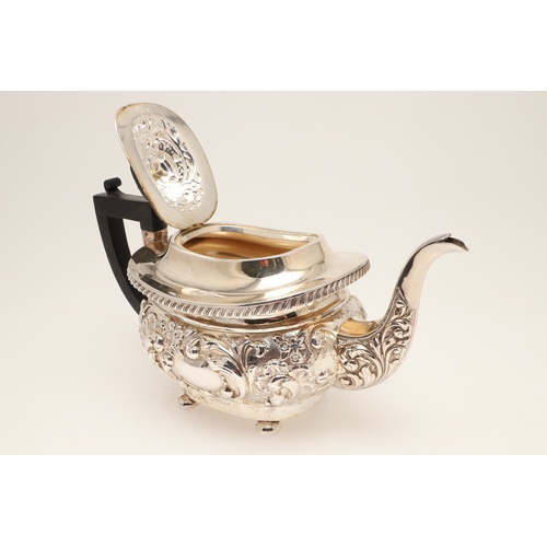 54 - A GEORGE V SILVER THREE PIECE TEA SET. Each of shaped oblong form, gadrooned rims over bands of repo... 