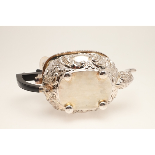 54 - A GEORGE V SILVER THREE PIECE TEA SET. Each of shaped oblong form, gadrooned rims over bands of repo... 