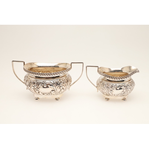 54 - A GEORGE V SILVER THREE PIECE TEA SET. Each of shaped oblong form, gadrooned rims over bands of repo... 