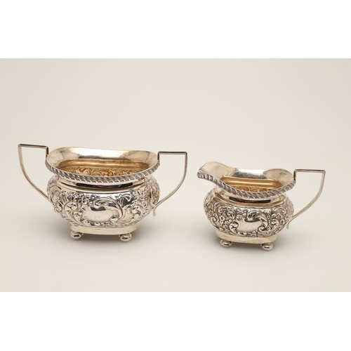 54 - A GEORGE V SILVER THREE PIECE TEA SET. Each of shaped oblong form, gadrooned rims over bands of repo... 