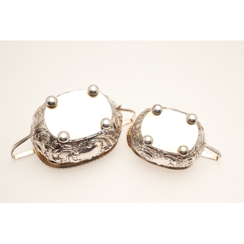 54 - A GEORGE V SILVER THREE PIECE TEA SET. Each of shaped oblong form, gadrooned rims over bands of repo... 