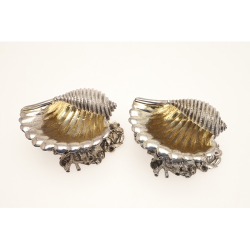 59 - A PAIR OF EARLY GEORGE IV SILVER SALTS IN THE FORM OF SEA SHELLS. On a cast naturalistic base, hallm... 