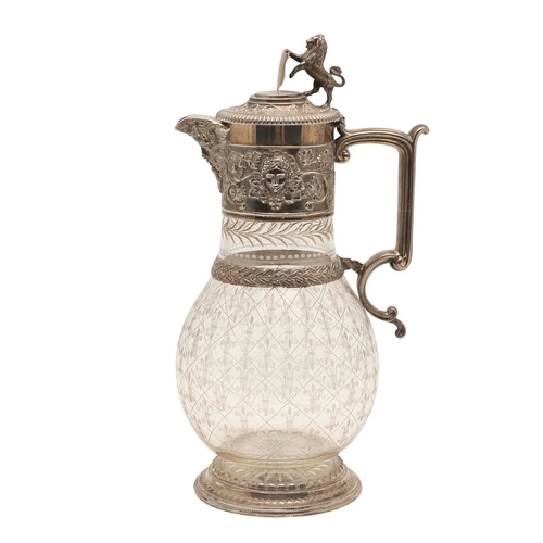 62 - A VICTORIAN SILVER MOUNTED GLASS CLARET JUG. Of bulbous form, the top with foliate vine and mask dec... 