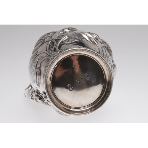 63 - A VICTORIAN SILVER WINE OR WATER JUG. The baluster body with repousse and chased decoration of water... 