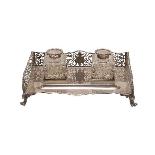 64 - A LATE VICTORIAN SILVER INK STAND. Of rectangular form with shaped front, gadrooned edging and pierc... 