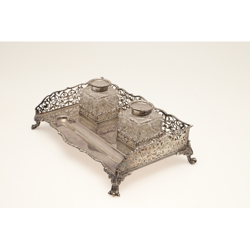 64 - A LATE VICTORIAN SILVER INK STAND. Of rectangular form with shaped front, gadrooned edging and pierc... 