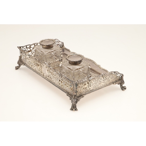 64 - A LATE VICTORIAN SILVER INK STAND. Of rectangular form with shaped front, gadrooned edging and pierc... 