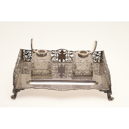 64 - A LATE VICTORIAN SILVER INK STAND. Of rectangular form with shaped front, gadrooned edging and pierc... 