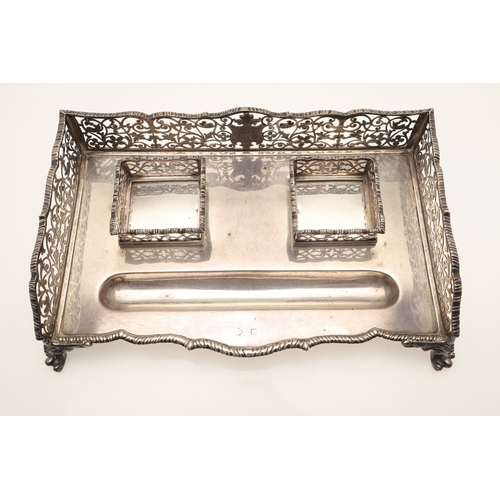 64 - A LATE VICTORIAN SILVER INK STAND. Of rectangular form with shaped front, gadrooned edging and pierc... 