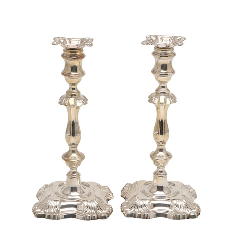 66 - A PAIR OF LATE VICTORIAN SILVER CANDLESTICKS. On shaped square bases (loaded), with knopped stems an... 