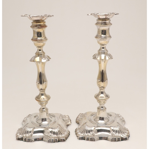 66 - A PAIR OF LATE VICTORIAN SILVER CANDLESTICKS. On shaped square bases (loaded), with knopped stems an... 