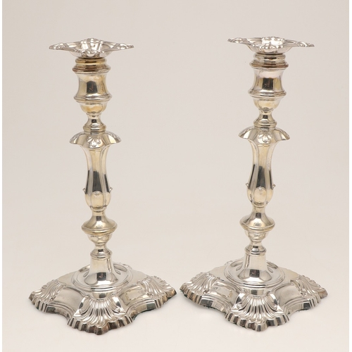 66 - A PAIR OF LATE VICTORIAN SILVER CANDLESTICKS. On shaped square bases (loaded), with knopped stems an... 