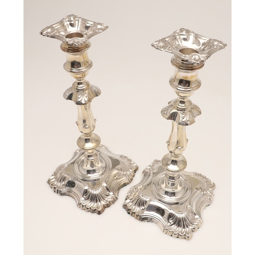 66 - A PAIR OF LATE VICTORIAN SILVER CANDLESTICKS. On shaped square bases (loaded), with knopped stems an... 