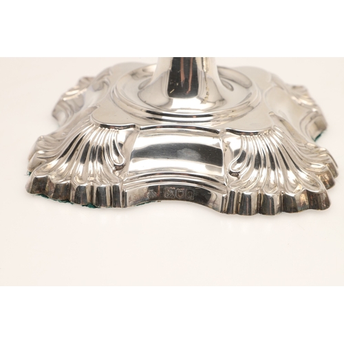 66 - A PAIR OF LATE VICTORIAN SILVER CANDLESTICKS. On shaped square bases (loaded), with knopped stems an... 