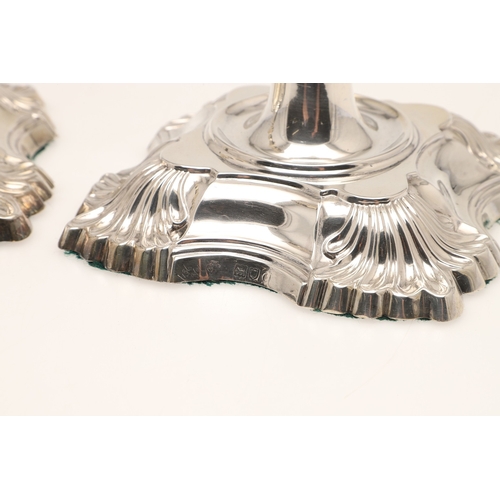 66 - A PAIR OF LATE VICTORIAN SILVER CANDLESTICKS. On shaped square bases (loaded), with knopped stems an... 