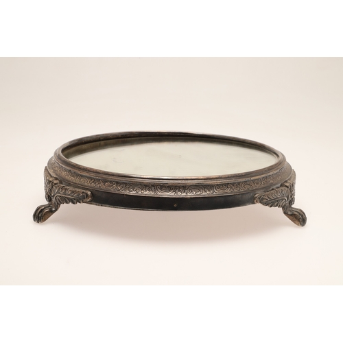 67 - A LATE VICTORIAN / EARLY EDWARDIAN SILVER MIRRORED CAKE STAND. Of circular form, the silver frame wi... 