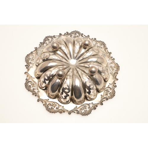 69 - A DECORATIVE EDWARDIAN SILVER BON BON DISH. The shaped circular form bowl with pierced stamped folia... 