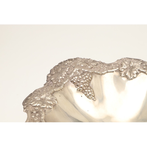 70 - AN EARLY EDWARDIAN SILVER TAZZA. With heavily embossed grape vine decoration, on a rounded base. Hei... 