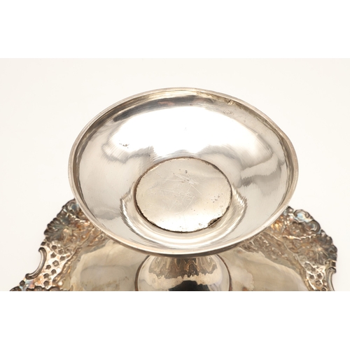 70 - AN EARLY EDWARDIAN SILVER TAZZA. With heavily embossed grape vine decoration, on a rounded base. Hei... 