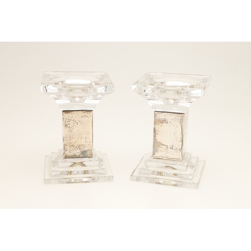 76 - A PAIR OF CARR'S OF SHEFFIELD GLASS AND SILVER FACED CANDLESTICKS AND A SILVER CANDLE STAND. The pai... 