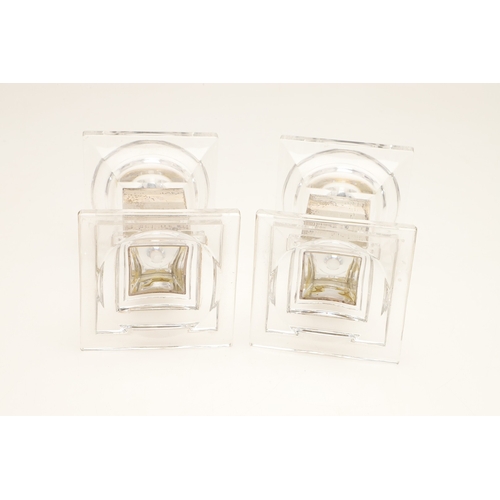 76 - A PAIR OF CARR'S OF SHEFFIELD GLASS AND SILVER FACED CANDLESTICKS AND A SILVER CANDLE STAND. The pai... 