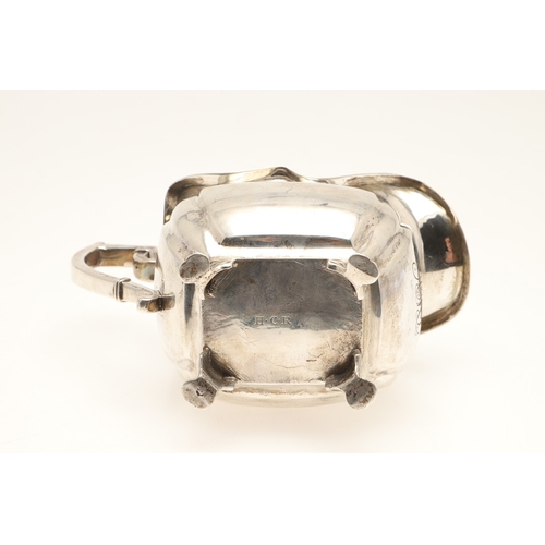 83 - A GEORGE III IRISH SILVER CREAM JUG. With gadrooned rim and stood on paw feet, engraved initials A &... 