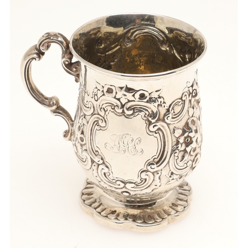 84 - A VICTORIAN SILVER ROCOCO DECORATED CHRISTENING MUG. Of baluster form, with floral and c-scroll deco... 