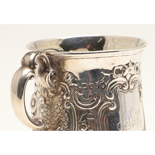 84 - A VICTORIAN SILVER ROCOCO DECORATED CHRISTENING MUG. Of baluster form, with floral and c-scroll deco... 