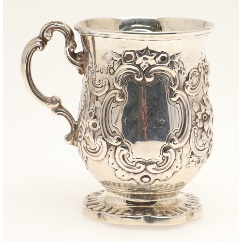 84 - A VICTORIAN SILVER ROCOCO DECORATED CHRISTENING MUG. Of baluster form, with floral and c-scroll deco... 