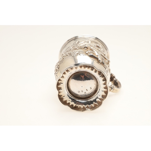 84 - A VICTORIAN SILVER ROCOCO DECORATED CHRISTENING MUG. Of baluster form, with floral and c-scroll deco... 